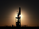 A pumpjack pulls oil from a Permian Basin oil field in Odessa, Tex. Slower economic growth, expected over the next few quarters,  could impact demand and the price for oil.