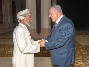 In this photo was released by Oman News Agency, Oman's Sultan Qaboos, left, receives Israeli Prime Minister Benjamin Netanyahu in Muscat, Oman, Friday, Oct. 26, 2018. Israel and Oman do not have diplomatic relations. The meeting was the first between leaders of the two countries since 1996 and former Israeli premier Yitzhak Rabin made a similar surprise visit to Oman two years earlier.