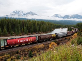 Rail cars loaded with Canadian wheat travel through the Rocky Mountains near Banff, Alberta. Recent reporting by Canadian National Railway Co. and Canadian Pacific Railway Ltd. shows the two companies have moved more than 30 million tonnes of Prairie grain since the summer.