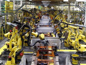 Robots weld the bed of a Ford F-150 truck at an assembly plant in Detroit, in 2018.