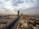 Road traffic passes skyscrapers on King Fahd highway in Riyadh, Saudi Arabia.