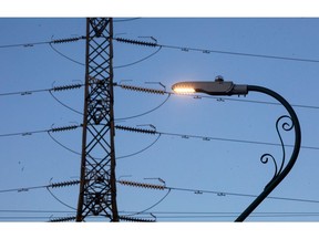 A street light alongside an electricity pylon in the U.K. Photographer: Bloomberg Creative Photos/Bloomberg Creative Collection