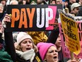 Teachers hold placards as they shout slogans while taking part in a protest organized by NEU and other affiliated trade unions in Saint Peter's square, in Manchester, on Feb. 1, 2023 as part of a national strike day.