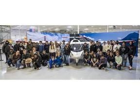 Students pose in front of aircraft at ICON Aircraft