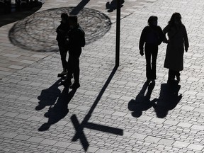 As Toronto Mayor John Tory prepares to step down after admitting to an inappropriate relationship with a staffer, experts say preparation is key to protect both employees and employers from the risks such relationships create. People are silhouetted as they visit a shopping district in Beijing, Tuesday, Nov. 15, 2022.