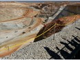 Visitors cast shadows as they look out over part of the main pit of Newcrest Mining Ltd.'s Telfer Mine in the Pilbara region of Western Australia.