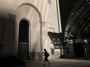 A woman walks through Toronto's financial district.