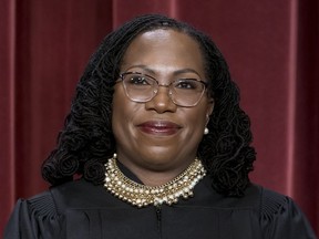 FILE - Associate Justice Ketanji Brown Jackson stands as she and members of the Supreme Court pose for a new group portrait following her addition, at the Supreme Court building in Washington, Oct. 7, 2022. Jackson has written her first majority opinion for the Supreme Court. The opinion released Tuesday in a dispute between states over unclaimed money is one of roughly a half dozen she is expected to write by the time the court finishes its work for the summer, usually in late June. The decision was unanimous, though all the justices didn't join the whole opinion.