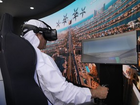 A man experiences a driving simulator of a flying taxi at the Dubai Roads and Transportation Authority's stand during the World Government SummitWLD in Dubai, United Arab Emirates, Monday, Feb 13, 2023. Dubai again is planning for the takeoff of flying taxis in this futuristic city-state on the Arabian Peninsula, offering its firmest details yet Monday for a pledged launch by 2026.