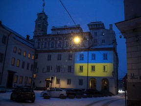The Vilnius University building is illuminated with the colors of Ukraine to mark the one-year anniversary of Russia's invasion of the country, in Vilnius, Lithuania, Friday, Feb. 24, 2023.