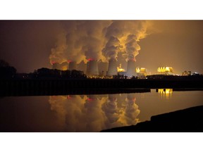 Chimneys emit vapor at Jaenschwalde lignite power plant, operated Vattenfall AB, at dusk in Peitz, Germany. Photographer: Krisztian Bocsi/Bloomberg