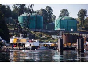 Oil storage tanks sit at the Kinder Morgan Inc. Westridge Marine Terminal during an emergency response exercise in Burnaby, British Columbia, Canada, on Wednesday, Sept. 19, 2018. A Canadian court's decision to nullify approval of the Trans Mountain Expansion Project will increase crude-by-rail transport in the near term and will likely have a "negative impact on Canadian output growth in the longer term," the International Energy Agency said earlier this month.