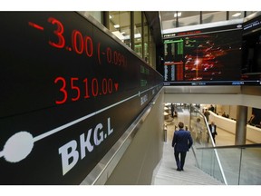 An employee passes share price information displayed on an electronic ticker board inside the London Stock Exchange Group Plc's offices in London, U.K., on Wednesday, May 29, 2019. While the FTSE 100 Index has climbed about 15 percent since June 2016 in local currency, it's down in both euro and dollar terms.