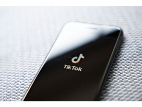 Signage for ByteDance Ltd.'s TikTok app is displayed on a smartphone in an arranged photograph taken in Arlington, Virginia, U.S., on Monday, Aug. 3, 2020. In a bid to salvage a deal for the U.S. operations of TikTok, Microsoft Corp. Chief Executive Officer Satya Nadella spoke with President Donald Trump by phone about how to secure the administrations blessing to buy the wildly popular, but besieged, music video app.