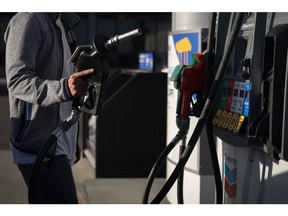 A customer refuels at a Chevron Corp. gas station in Calgary, Alberta, Canada, on Friday, Aug. 14, 2020. Despite a 24% drop in fuel and petroleum product volumes, Parkland Corp., which runs gas stations under the Chevron, Esso, Pioneer and other brands in Canada, posted 12.1% growth in same-store sales at its convenience stores last quarter.