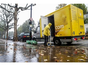 A driver for Ocado Group Plc makes deliveries in the rain in the St John's Wood district of London, U.K., on Thursday, Oct. 8, 2020. Covid-19 lockdown enabled online and app-based grocery delivery service providers to make inroads with customers they had previously struggled to recruit, according the Consumer Radar report by BloombergNEF.