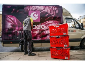 A delivery driver for Ocado Group Plc prepares groceries for delivery to an apartment in London, U.K., on Tuesday, Sept. 29, 2020. Covid-19 lockdown enabled online and app-based grocery delivery service providers to make inroads with customers they had previously struggled to recruit, according the Consumer Radar report by BloombergNEF.