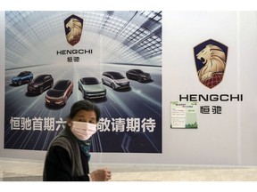 A pedestrian walks past China Evergrande Group New Vehicle Group Ltd.'s yet-to-open Hengchi showroom in Shanghai, China, on Friday, April 2, 2021. China Evergrande Group's new-energy vehicle startup Evergrande NEV reported a loss that widened by a yawning 67% with still no immediate sign of mass production of electric cars. Photographer: Qilai Shen/Bloomberg