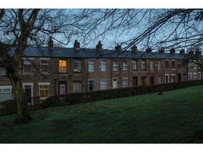 Lights on at residential homes in a row of terraced houses at dawn in the Millbrook district of Greater Manchester, U.K., on Tuesday, March 1, 2022. About 6 million families in the U.K. will pay a combined 3.9 billion-pound ($5.2 billion) surcharge on their energy bills when the price cap rises in April, according to think tank the Resolution Foundation. Photographer: Anthony Devlin/Bloomberg