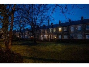 Lights on at residential homes in a row of terraced houses at dawn in the Millbrook district of Greater Manchester, U.K., on Tuesday, March 1, 2022.