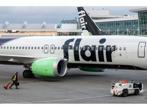 A Flair Airlines aircraft at Vancouver International Airport (YVR) in Vancouver, British Columbia, Canada, on Monday, March 7, 2022. Flair Airlines has added more than a dozen Boeing 737s to its fleet, with plans to grow its fleet to 50 planes by 2025, Toronto Star reports.