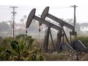 LOS ANGELES, CALIFORNIA - MARCH 28: An oil pumpjack (R) operates as another (C) stands idle on March 28, 2022 in Los Angeles, California. U.S. oil prices fell 7 percent to $105.96 per barrel while Brent crude lost 6.8 percent over demand concerns as China begins to implement a mass COVID-19 lockdown in Shanghai.