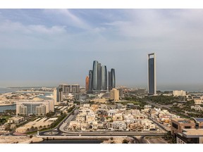 The headquarters of the Abu Dhabi National Oil Co. (ADNOC), right, and Etihad Towers, center, surrounded by residential and commercial properties in Abu Dhabi, United Arab Emirates, on Sunday, April 10, 2022. Abu Dhabi regulators approved a framework for special purpose acquisition companies, looking to capture some of the blank-check boom that has gripped global markets for the past two years.