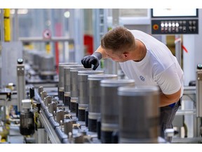 An employee checks the finished components on the electric motor rotor production line at the SalzGiga fuel cell gigafactory, operated by Volkswagen Group Components, in Salzgitter, Germany, on Wednesday, May 18, 2022. VW's future battery hub at Salzgitter will start production in 2025 for the company's volume cars.