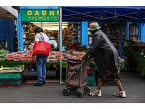 Shoppers at fresh grocery stalls at Surrey Street Market in Croydon, UK, on Monday, July 25, 2022. UK inflation running at the fastest pace since the early 80s. Photographer: Hollie Adams/Bloomberg