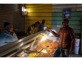 A light illuminates a food store in the Imizamo Yethu informal settlement in the Hout Bay district of Cape Town, South Africa, on Wednesday, Aug. 3, 2022. South Africa's state-owned power utility Eskom Holdings SOC Ltd. warned it may have to implement rolling blackouts for the first time in more than a week due to a shortage of generation capacity.