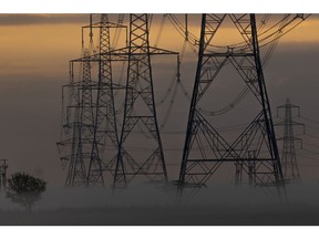 Electricity pylons and power lines in morning mist on the Isle of Grain, UK, on Monday, Aug. 22, 2022. The UK is about to receive liquefied natural gas from far-off Australia for the first time in at least six years, highlighting the European regions desperation in grappling with its worst energy crisis in decades. Photographer: Jason Alden/Bloomberg