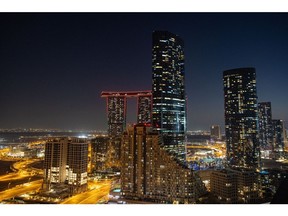 Residential high-rise buildings at night in the Al Reem district of Abu Dhabi. Photographer: Christopher Pike/Bloomberg