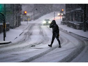 NORTHWICH, UNITED KINGDOM- DECEMBER 10: A man makes his way through a snow flurry, the first significant snow fall in Cheshire this Winter on December 10, 2022 in Northwich, United Kingdom. The UK Health Security Agency (UKHSA) issued a cold-weather alert that will run until Monday morning, as many across the UK struggle with home-heating costs.