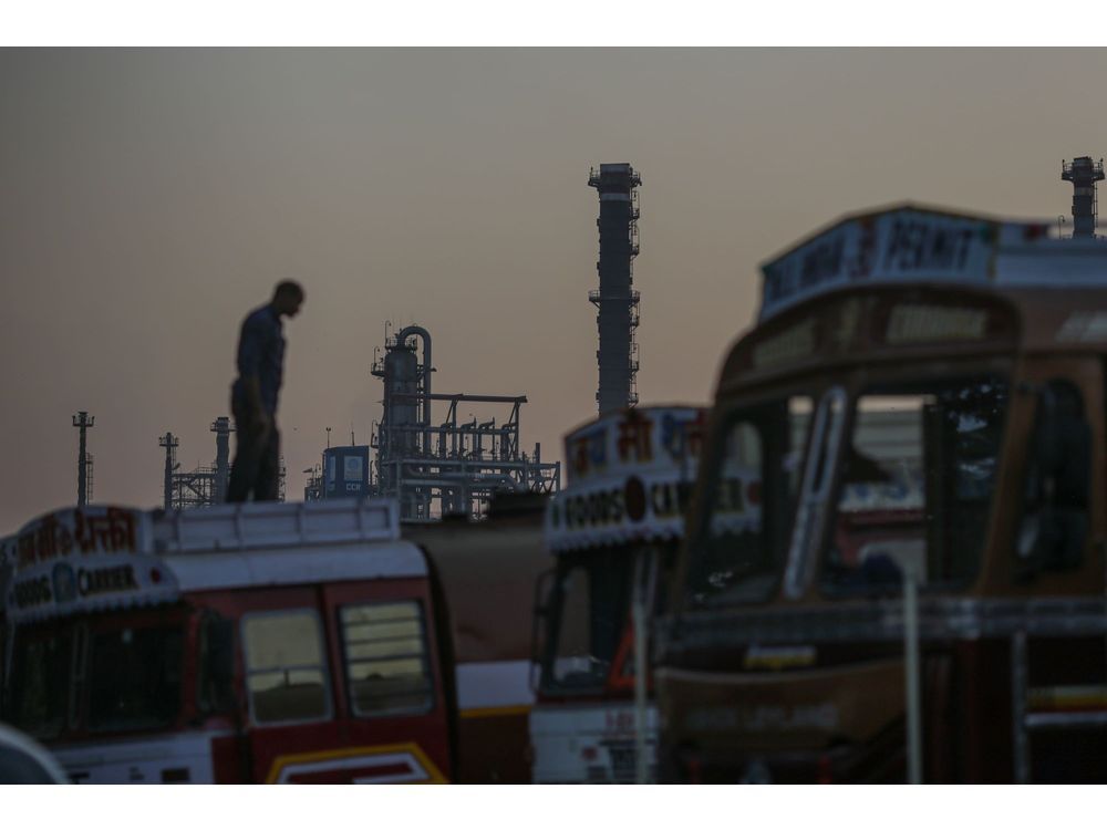 A truck driver stands on a truck near an oil refinery, operated by Bharat Petroleum Corp. Ltd., in Mumbai, India, on Saturday, Dec. 10, 2022. A senior official at India's oil ministry told reporters this month India has been buying oil from about 30 countries, and will continue to buy from anywhere including Russia beyond January. Photographer: Dhiraj Singh/Bloomberg