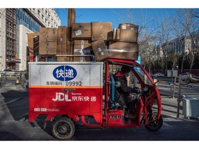 A JD.com worker delivers packages in Beijing, China, on Thursday, Dec. 22, 2022.  Source: Bloomberg