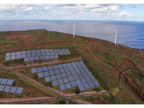 Wind turbines beyond an array of solar panels on the hillside in the Canical district of Madeira, Portugal, on Thursday, Feb. 9, 2023. Renewables are now among the cheapest forms of electricity, especially after an energy crunch and the Ukraine war bolstered gas, oil and coal. Photographer: Zed Jameson/Bloomberg