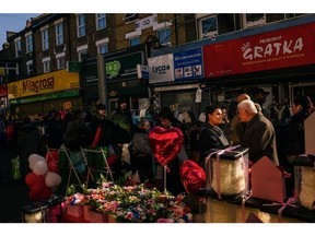 Shoppers browse flowers and Valentine's Day gifts at a stall on Walthamstow Market in London on Feb. 14.