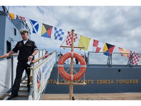 A member of the Russian navy disembarks the Russian frigate Admiral Gorshkov in South Africa on Feb. 22.