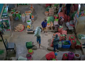 A worker carries a sack of vegetables at a market in Colombo, Sri Lanka, on Monday, March 13, 2023. Sri Lanka's GDP likely shrank at a slower pace on a quarter-on-quarter basis in the fourth quarter of 2022, falling 0.5% quarter on quarter, less than a 6.1% drop in the third quarter of 2022, according to Bloomberg Economics' estimates.