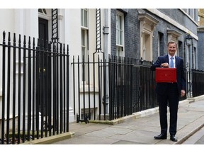Jeremy Hunt, UK chancellor of the exchequer, holding the despatch box outside 11 Downing Street in London, UK, on Wednesday, March 15, 2023. Hunt will pledge to drive economic growth by unblocking business investment in his first budget, in which he will set out tax-and-spend policies for the last full year before the next election.