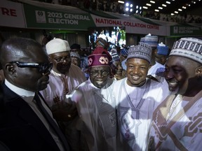 President-Elect Bola Tinubu, center-left, is congratulated by party dignitaries after receiving his certificate at a ceremony in Abuja, Nigeria, Wednesday, March 1, 2023. Election officials declared Tinubu the winner of Nigeria's presidential election Wednesday, keeping the ruling party in power in Africa's most populous nation.