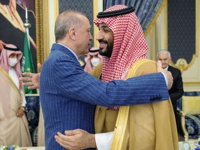 FILE - In this photo released by the Saudi Royal Palace, Turkish President Recep Tayyip Erdogan, left, hugs Saudi Arabia's Crown Prince Mohammed bin Salman before a meeting in Jiddah, Saudi Arabia, April 28, 2022. Saudi Arabia said Monday, March 6, 2023, it deposited $5 billion into the Turkish central bank, likely helping Ankara firm up its long-weakening currency, the lira, after last month's massive earthquake that struck southeast Turkey and northern Syria.