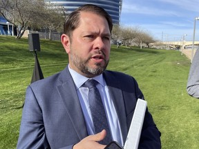 Rep. Ruben Gallego, D-Ariz., talks to reporters outside the Silicon Valley Bank office in Tempe, Ariz., Tuesday, March 14, 2023. Gallego, who is running for Senate, slammed independent Sen. Kyrsten Sinema for backing a bank deregulation bill he says contributed to the bank's collapse.