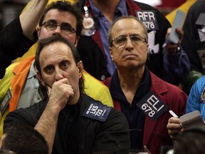 Traders watch prices in the futures pit at the Chicago Mercantile Exchange on March 17, 2008 when stocks plunged on news of the near collapse and takeover of Bear Stearns.