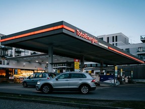 Motorists refuel at a TotalEnergies SE gas station in Berlin. Canadian retailer Alimentation Couche-Tard Inc has agreed to buy TotalEnergies' almost 2,200 gasoline stations in Europe.