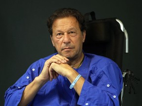 FILE - Former Pakistani Prime Minister Imran Khan speaks during a news conference in Shaukat Khanum hospital, where is being treated for a gunshot wound in Lahore, Pakistan, on Nov. 4, 2022. Pakistani police used water cannons and fired tear gas to disperse supporters of Khan Wednesday, March 8, 2023, in the eastern city of Lahore. Two dozen Khan supporters were arrested for defying a government ban on holding rallies, police said.