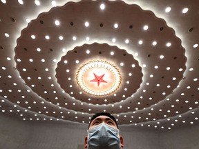 A security officer stands guard after the second plenary session of the National People's Congress (NPC) at the Great Hall of the People in Beijing on March 7, 2023.