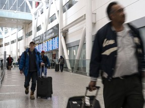 Passengers arrive at Pearson Airport in Mississauga, Ont. on Tuesday, March 14, 2023. The number of air passenger complaints to Canada's transport regulator has more than tripled over the past year, soaring past 42,000.