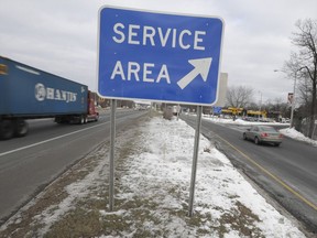 FILE - Motorists drive by a sign pointing to the entrance of a rest stop along Interstate 95 in Milford, Conn., on Jan. 5, 2010. Connecticut is suing the operator of the state's 23 highway rest stops, alleging the company is refusing to pay more than $2.7 million in back wages owed to food service workers for Subway, Dunkin' and other restaurant chains, state Attorney General William Tong announced Friday, March 10, 2023.