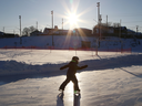 A child skates as the sun starts to set in Sudbury, Ont.